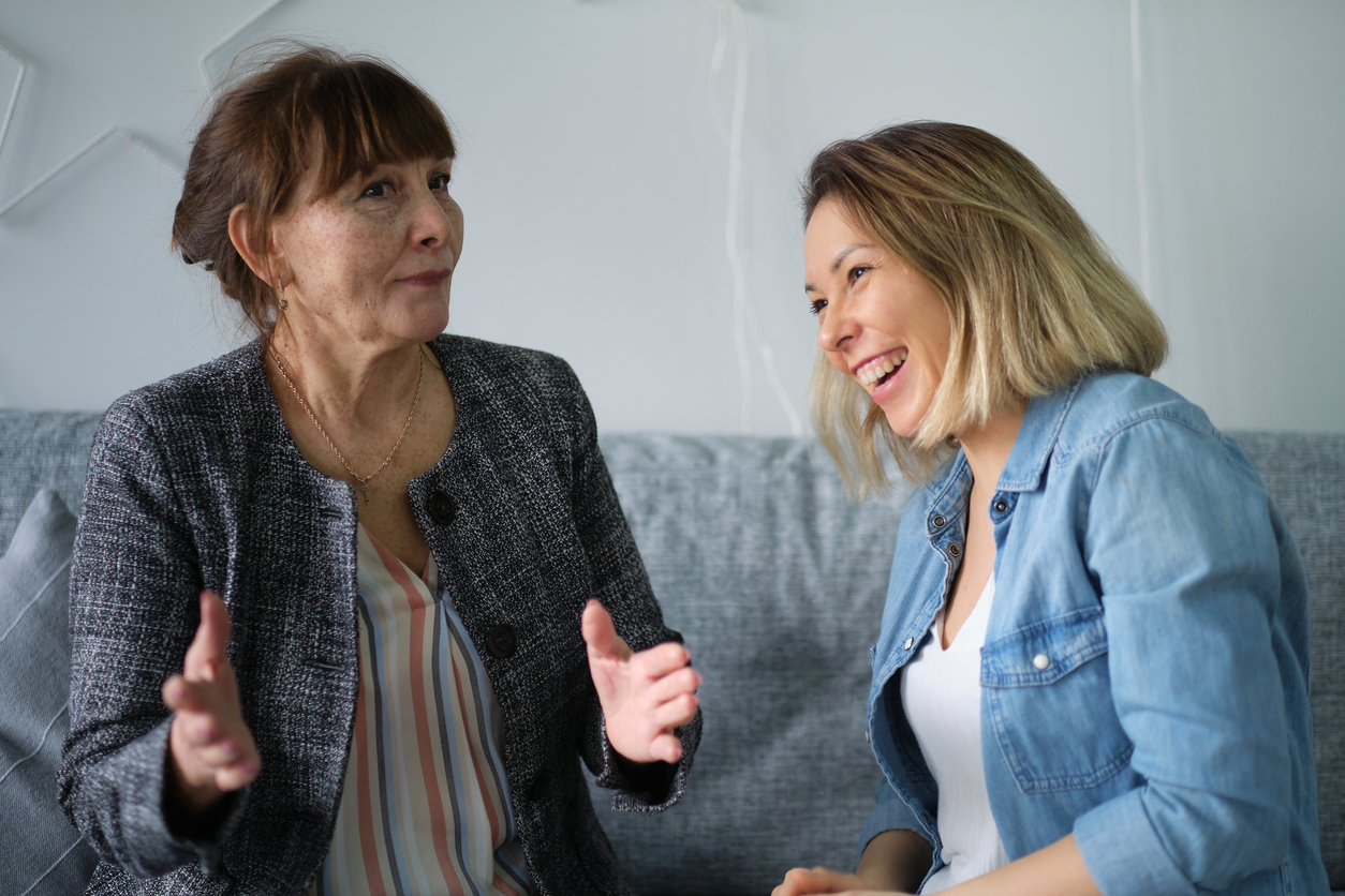 Two middle-aged women laughing together